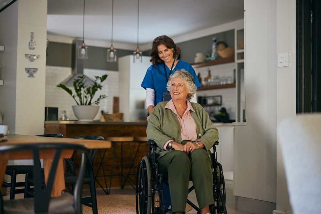 An in-home caregiver helps her client move around in her wheelchair.