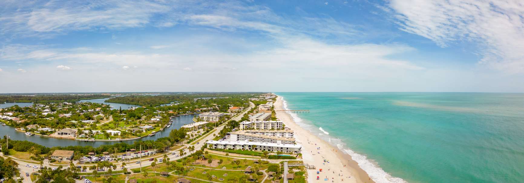 Arial panorama at Vero Beach, FL, along the coastline with teal water.